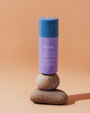 Nuria Calm Daily Moisturizer -- bottle balanced on rocks