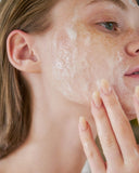 Nuria Defend Cleanser - woman with lather on face