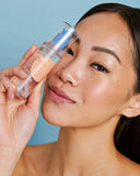 Nuria Defend Essence - woman holding bottle up to face