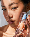 Nuria Defend Essence - woman holding bottle up to face