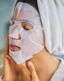Nuria Hydrate Replenishing Biocellulose Mask - woman applying mask to face