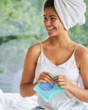 Nuria Hydrate Replenishing Biocellulose Mask - woman laughing and opening mask envelope