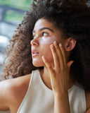 Nuria Hydrate Nourishing Under-Eye Masks - woman touching applied under-eye mask on her cheek