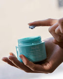 Nuria Hydrate Revitalizing Jelly Night Treatment - person holding jar and scooping one fingertip of jelly