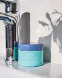 Nuria Hydrate Revitalizing Jelly Night Treatment - jar resting on sink ledge