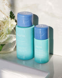Nuria Hydrate Refreshing Micellar Water - full and mini bottles positioned on back of sink