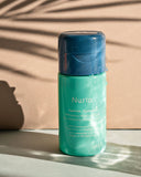 Nuria Hydrate Refreshing Micellar Water - bottle on counter with amber background