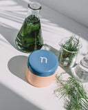 Defend Overnight Recovery Cream - jar on counter with natural ingredients - seaweed and algae