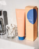 Nuria Defend Gentle Exfoliator - product and carton on sink