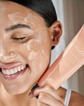 Nuria Defend Gentle Exfoliator - woman smiling with product on face