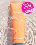 Nuria Defend Gentle Exfoliator - bottle underwater with ripples and sunlight