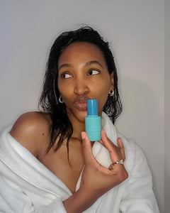Woman in Robe Holding Hydrate Moisturizing Serum