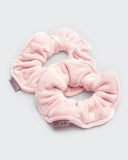 Kitsch pink towel scrunchies on gray background