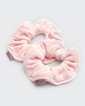Kitsch pink towel scrunchies on gray background