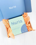 Spring Reset Kit, sealed package displayed in Nuria box, a $71 value. Contains (1) Mini Defend Gentle Exfoliator, (1) Mini Calm Daily Moisturizer, (1) Mini Hydrate Revitalizing Jelly Night Treatment, (1) Hydrate Nourishing Under-Eye Masks (five pairs per pack), and (2) Kitsch Towel Scrunchies.