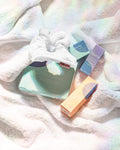 Spring Reset Kit, products displayed on a towel, a $71 value. Contains (1) Mini Defend Gentle Exfoliator, (1) Mini Calm Daily Moisturizer, (1) Mini Hydrate Revitalizing Jelly Night Treatment, (1) Hydrate Nourishing Under-Eye Masks (five pairs per pack), and (2) Kitsch Towel Scrunchies.