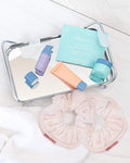 Nuria towel scrunchies on countertop with tray of Nuria mini products