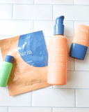 Nuria Teen Skin Glow Up Kit, products on a subway tile background