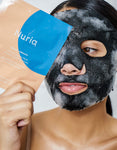 Nuria Defend Purifying Bubble Mask - woman holding package to face while wearing activated, bubbling mask