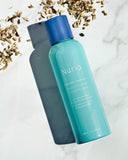 Nuria Hydrate Moisturizing Toner - bottle on marble counter with ingredient mallow root surrounding