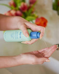 Nuria Rescue Rebalancing Cleanser - dispensing cleanser into palm of hand