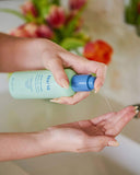 Nuria Rescue Rebalancing Cleanser - dispensing cleanser into palm of hand