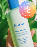 Nuria Rescue Rebalancing Cleanser - bottle on marble counter with ingredient, College Beauty Awards 2021 Winner