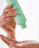 Nuria Rescue Pore-Minimizing Toner - person pouring product into hand
